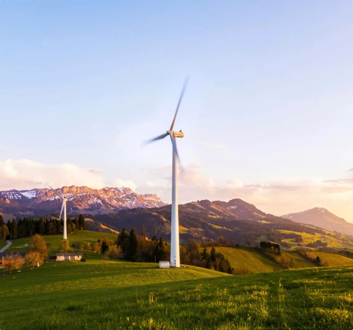 An attractive mountainous scene with two wind turbines