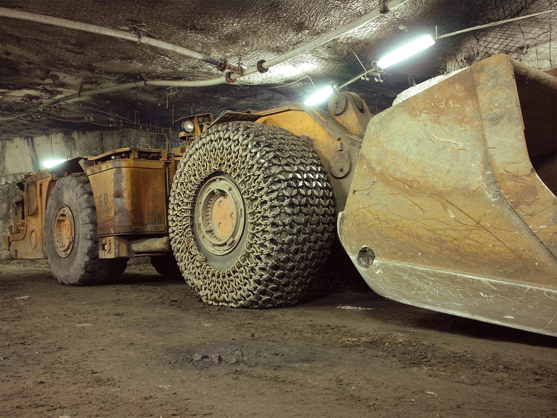 A large scale earth moving vehicle in an underground mine fitted with pewag TPC