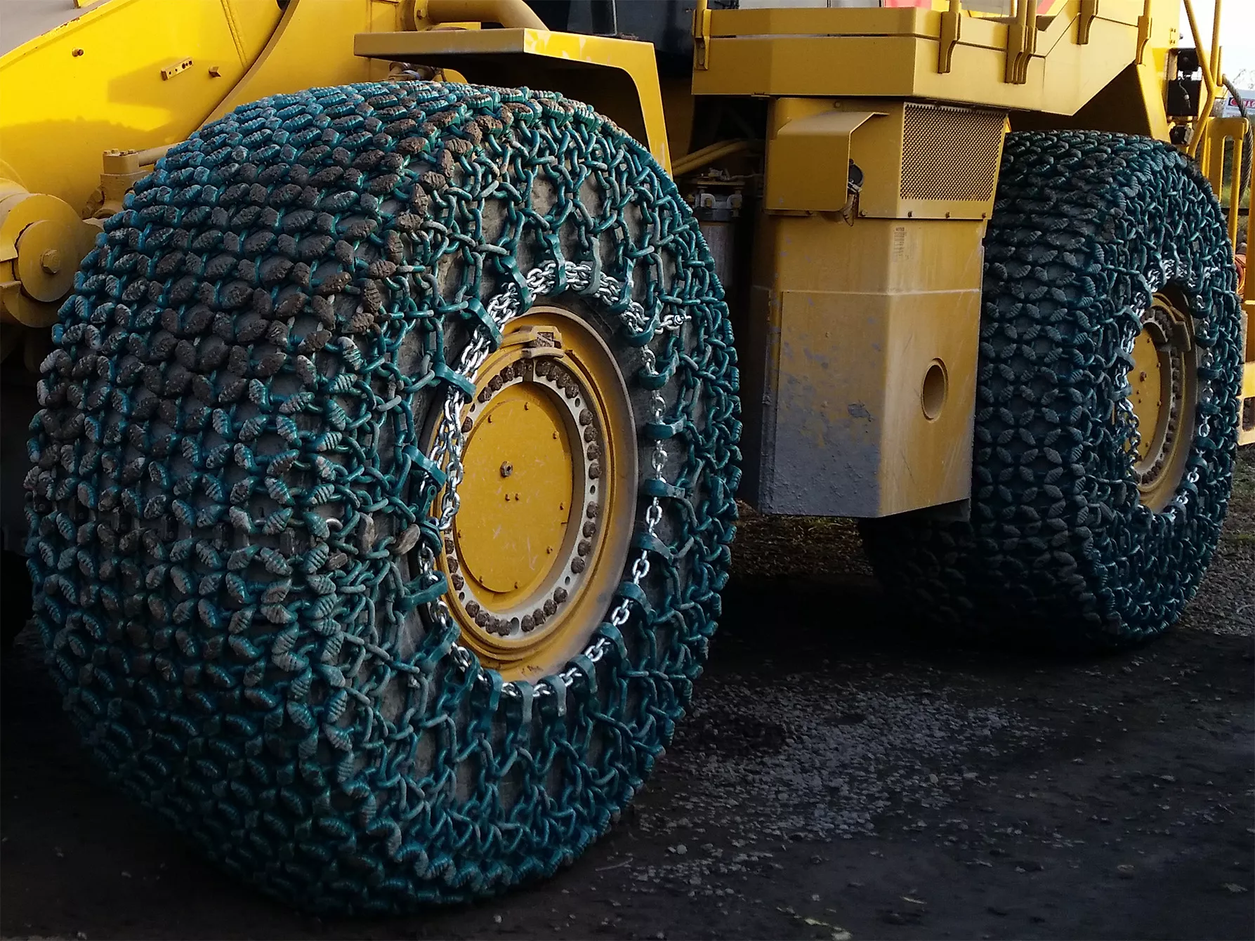 A close up of a large earth moving vehicle fitted with pewag tyre protection chains TPC