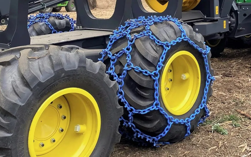 pewag forstgrip forestry tire chains fitted to a skidder tire in a forest