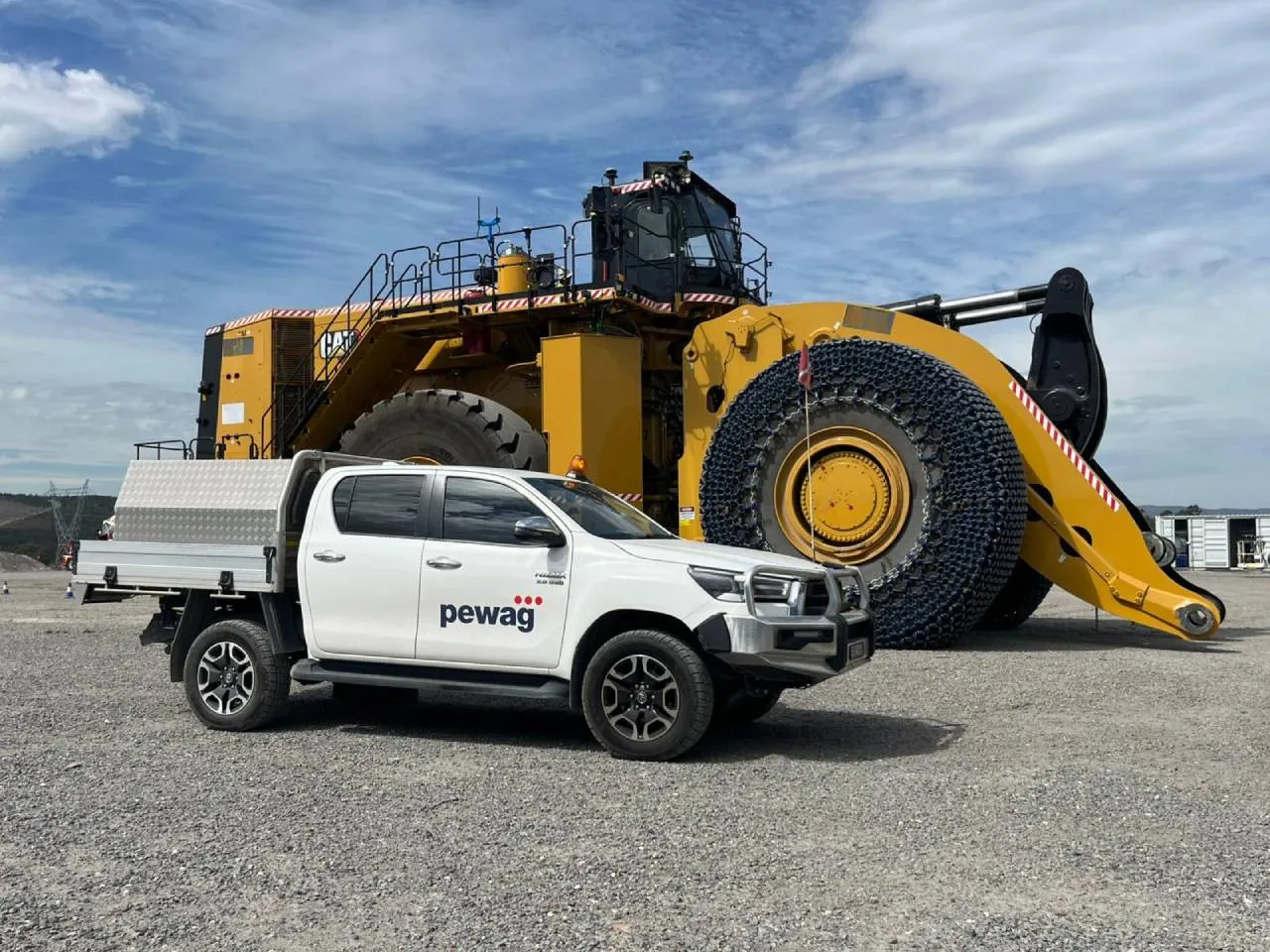 A pewag Australia Ute in front of a huge earthmover vehicle fitted with TPC